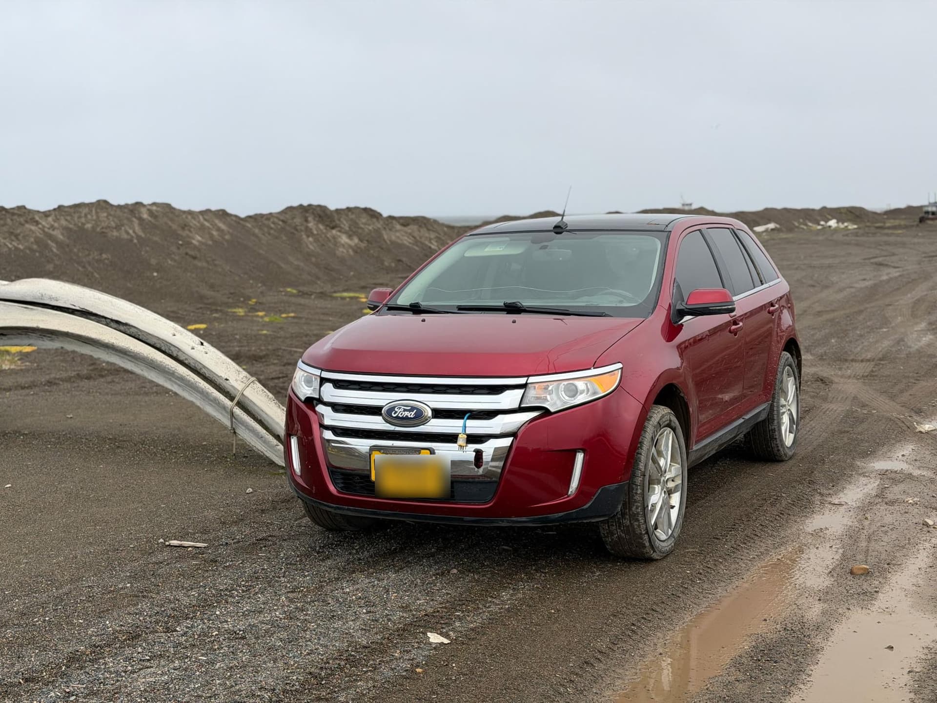 2012 Ford Edge, front three-quarter view, on a gravel road in Utqiagvik, Alaska